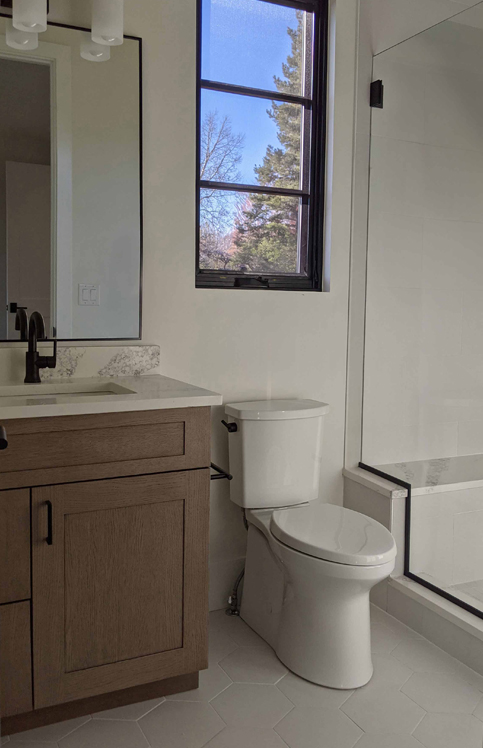 secondary off white bathroom with stained cabinets