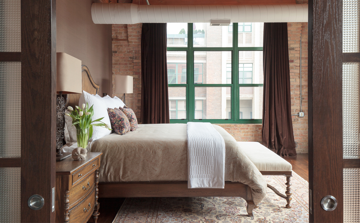 velvet drapery in brick loft bedroom