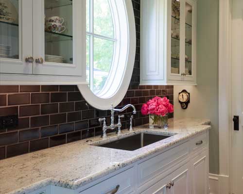 butlers pantry with black subway tile