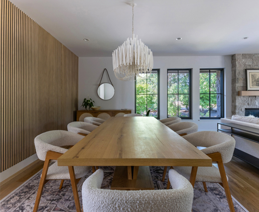 Warm wood dining table and light tones create a serene dining space — Boulder interior design influenced by Scandinavian simplicity