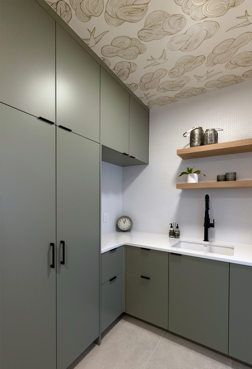 Stylish green laundry room with wood countertops and open storage — Boulder interior design for elevated everyday living