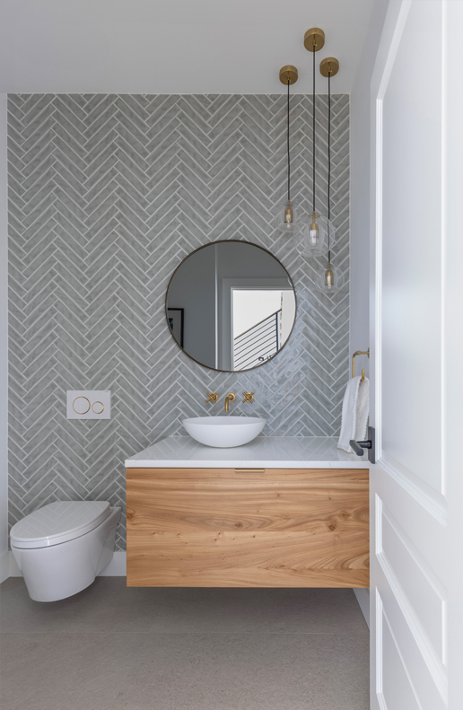 Modern powder room with asymmetrical mirror and floating wood vanity — bold bathroom ideas from a Colorado design firm