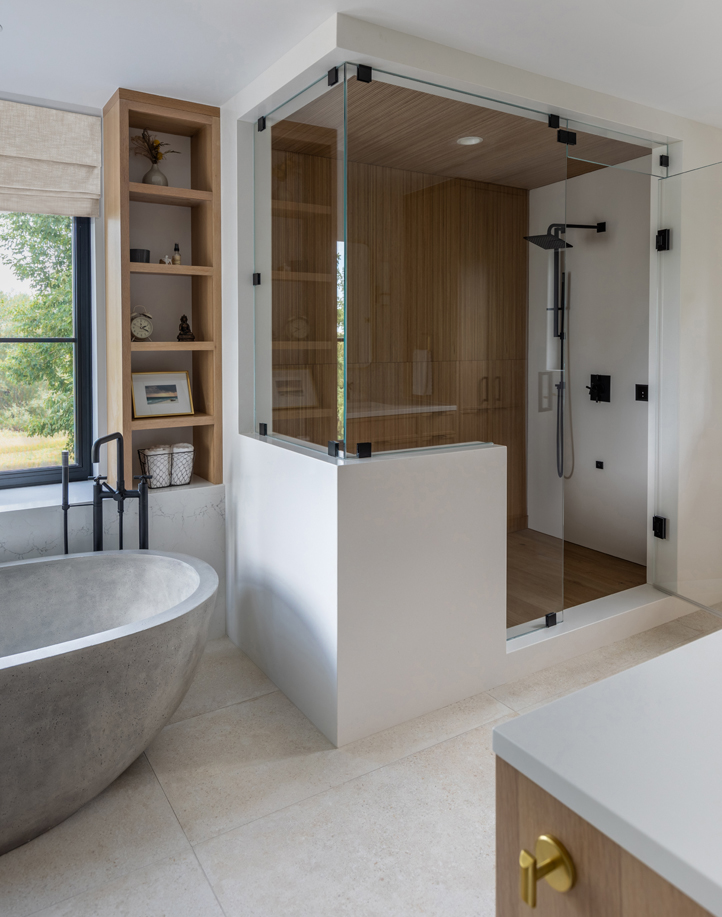 Spa-like primary bathroom with freestanding tub, sleek vanity, and natural textures — modern Boulder interior design by Denver professionals